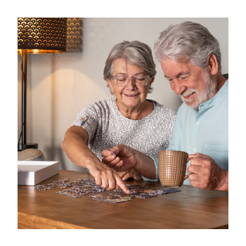 Image of two older adults working on a puzzle