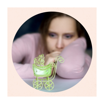 Out of focus person with toy carriage in the foreground